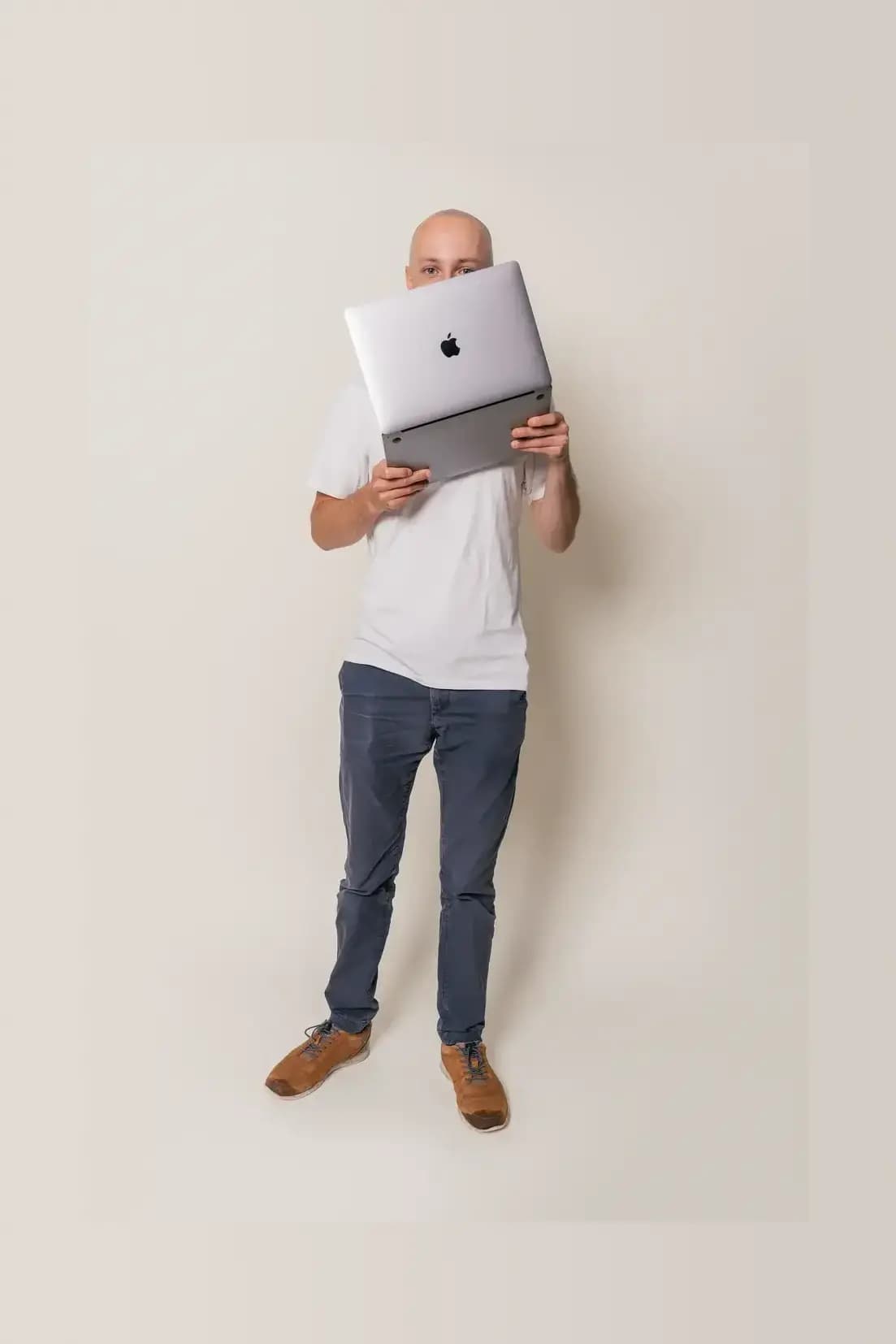 Picture of a men posing with a laptop.