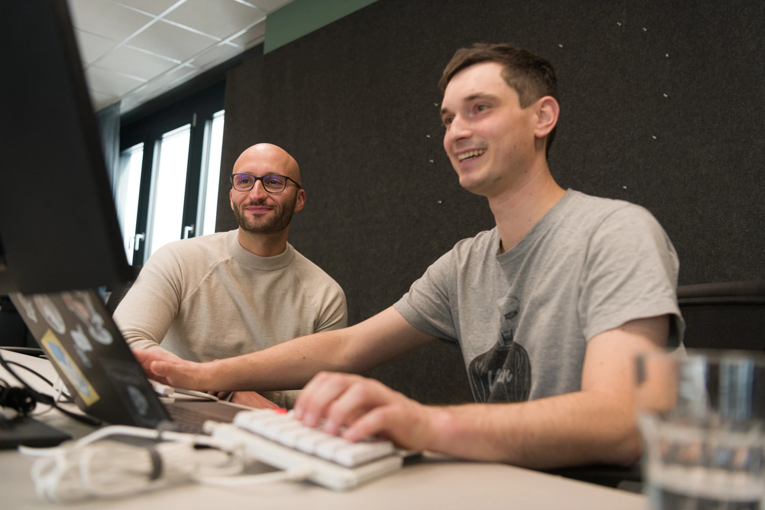 Two guys working on a laptop